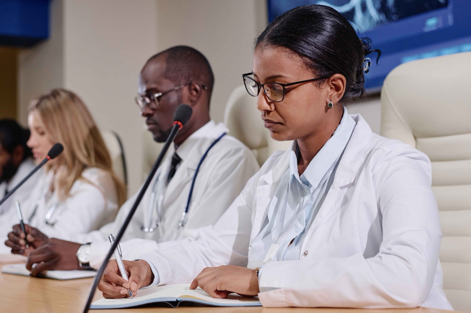 Healthcare professionals seated at a panel table