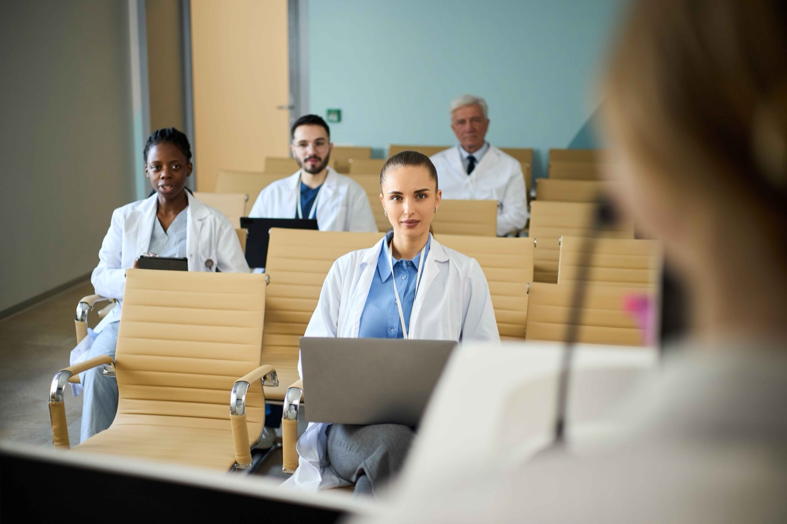 A diverse group of medical researchers seated together in a conference room