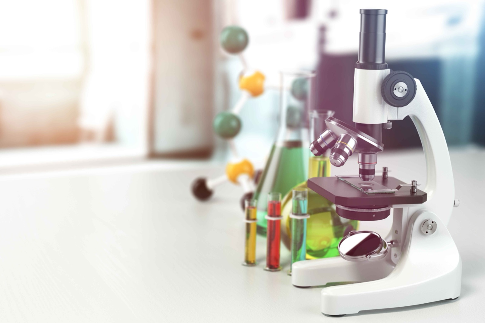 A microscope, laboratory flasks, and a molecular model on a lab bench